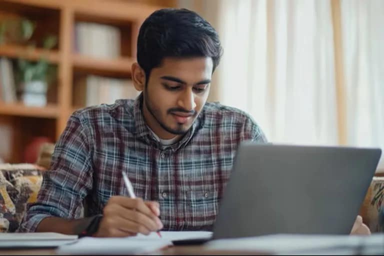 College student making notes during bachelor courses online study session