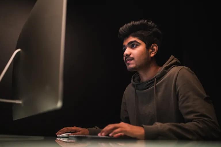 MCA student developing software applications in a university computer lab