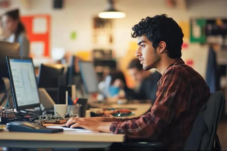 BCA student learning programming in a modern computer laboratory